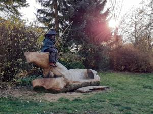 Statue of a waterman by a village pond